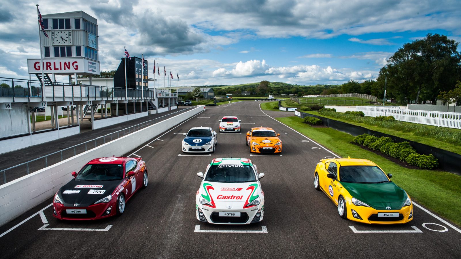 Six Toyota GT86s with retro liveries line up on the grid at Goodwood