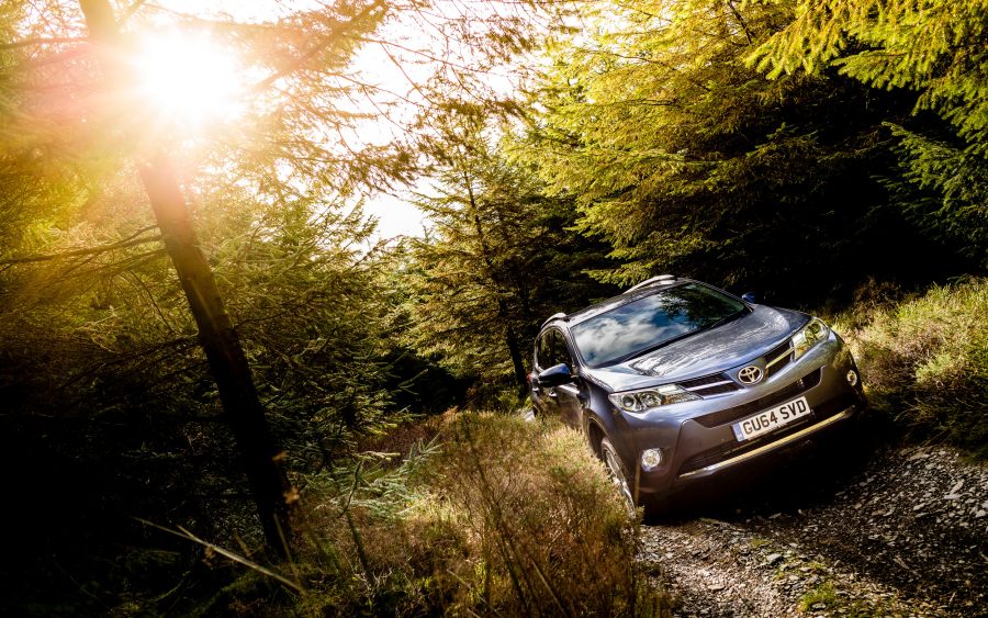 Toyota RAV4 Hybrid drives along gravel lane