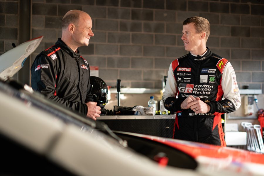 BTCC driver Rory Butcher talks to Toyota's Jason Stanley in a pit garage