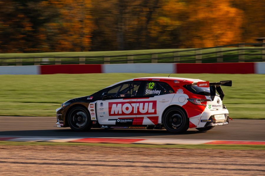 A Toyota Corolla touring car speeds past on the track
