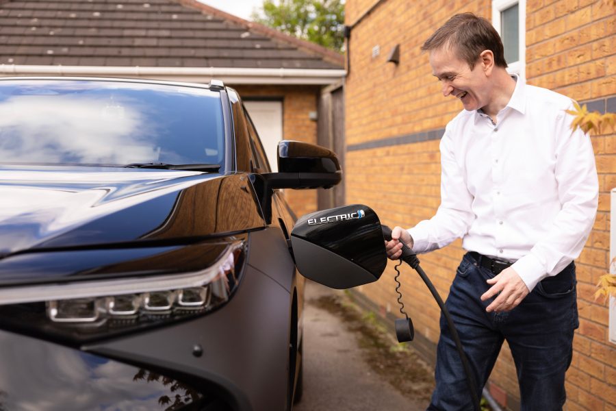 Toyota bZ4X owner plugging in an EV charger