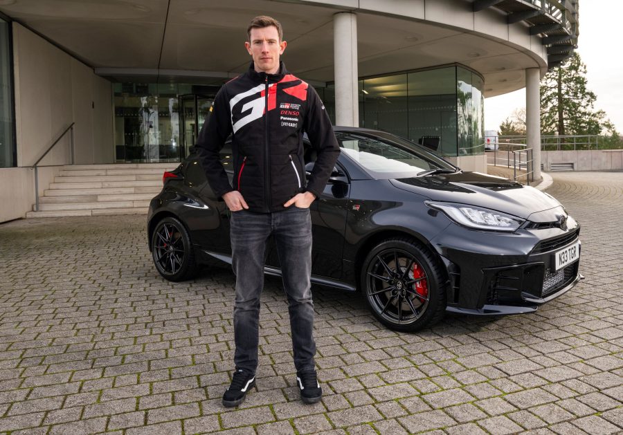 Elfyn Evans poses with his new Toyota GR Yaris outside Toyota GB's headquarters