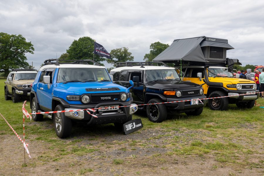 MR2 day Toyota FJ Cruisers in a field