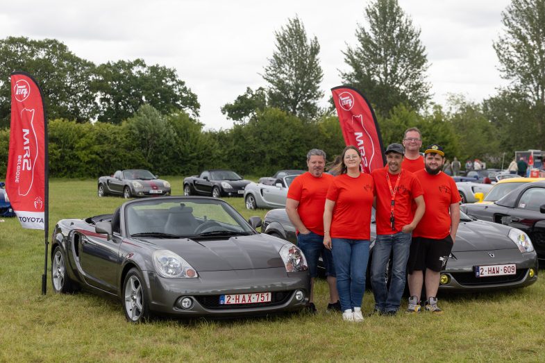 MR2 National Driver's Day flags and people standing in front of 2 seater cars Toyota