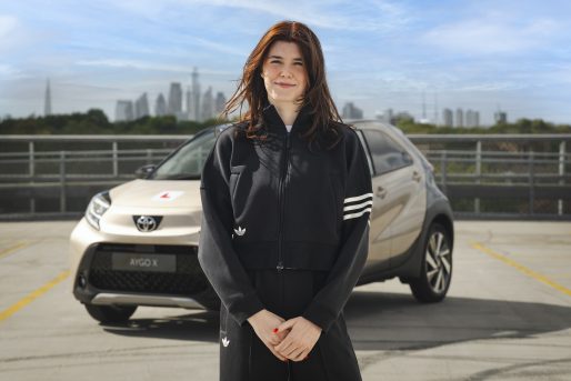 Andrea Spendolini-Sirieix stands in front of the Toyota Aygo X, ready to learn to drive