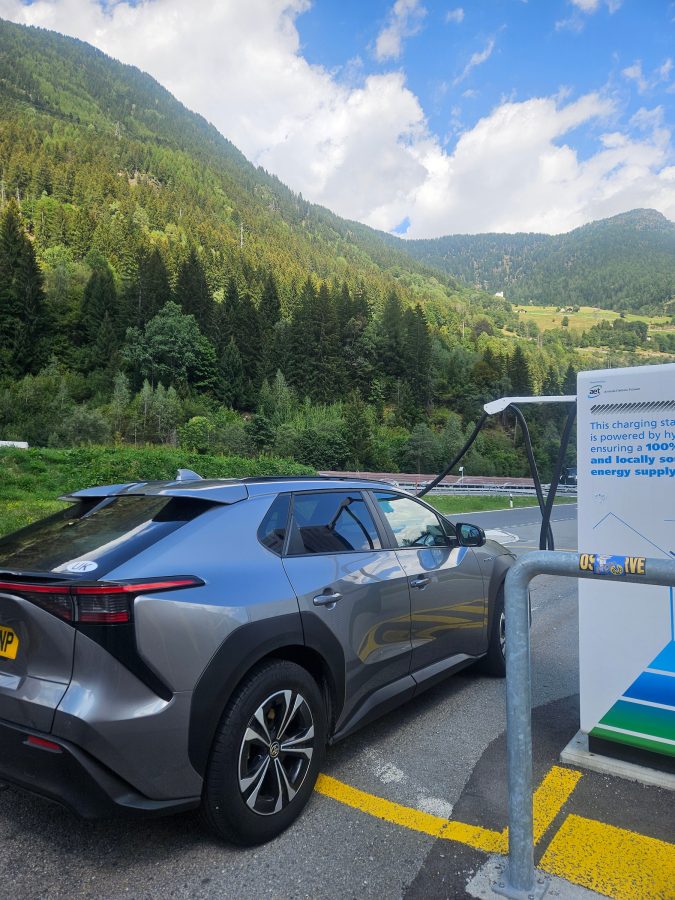 Toyota bZ4X at an electric charge point in the European mountains on the Tucker family road-trip.